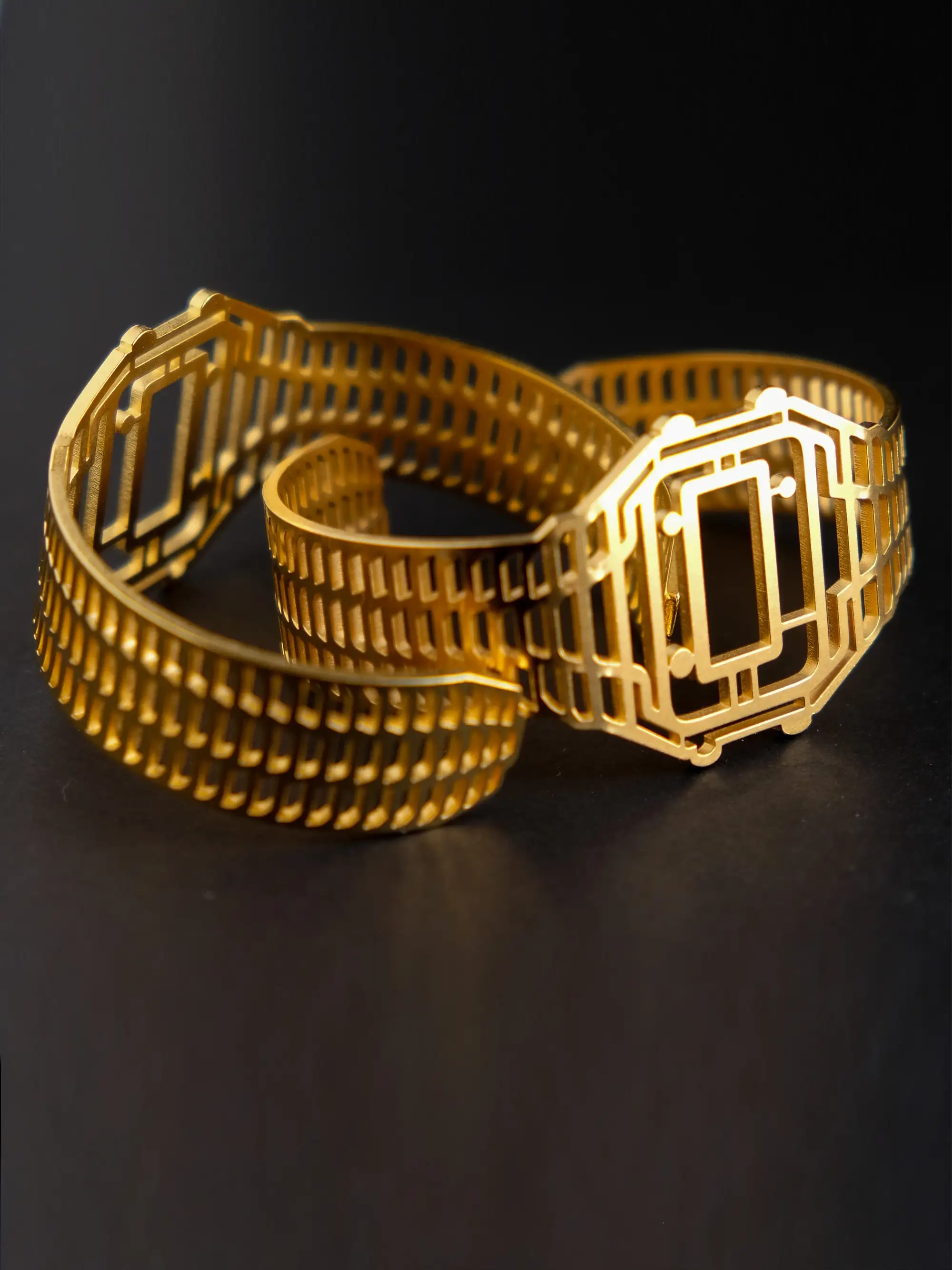 Two TIMEPEACE vintage Casio-inspired golden bracelets, minimalist style, watch-inspired timepiece jewelry from front on black background