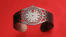 TIMEPEACE minimalist dark grey bracelet, watch-inspired timepiece jewelry without time lying on red background 