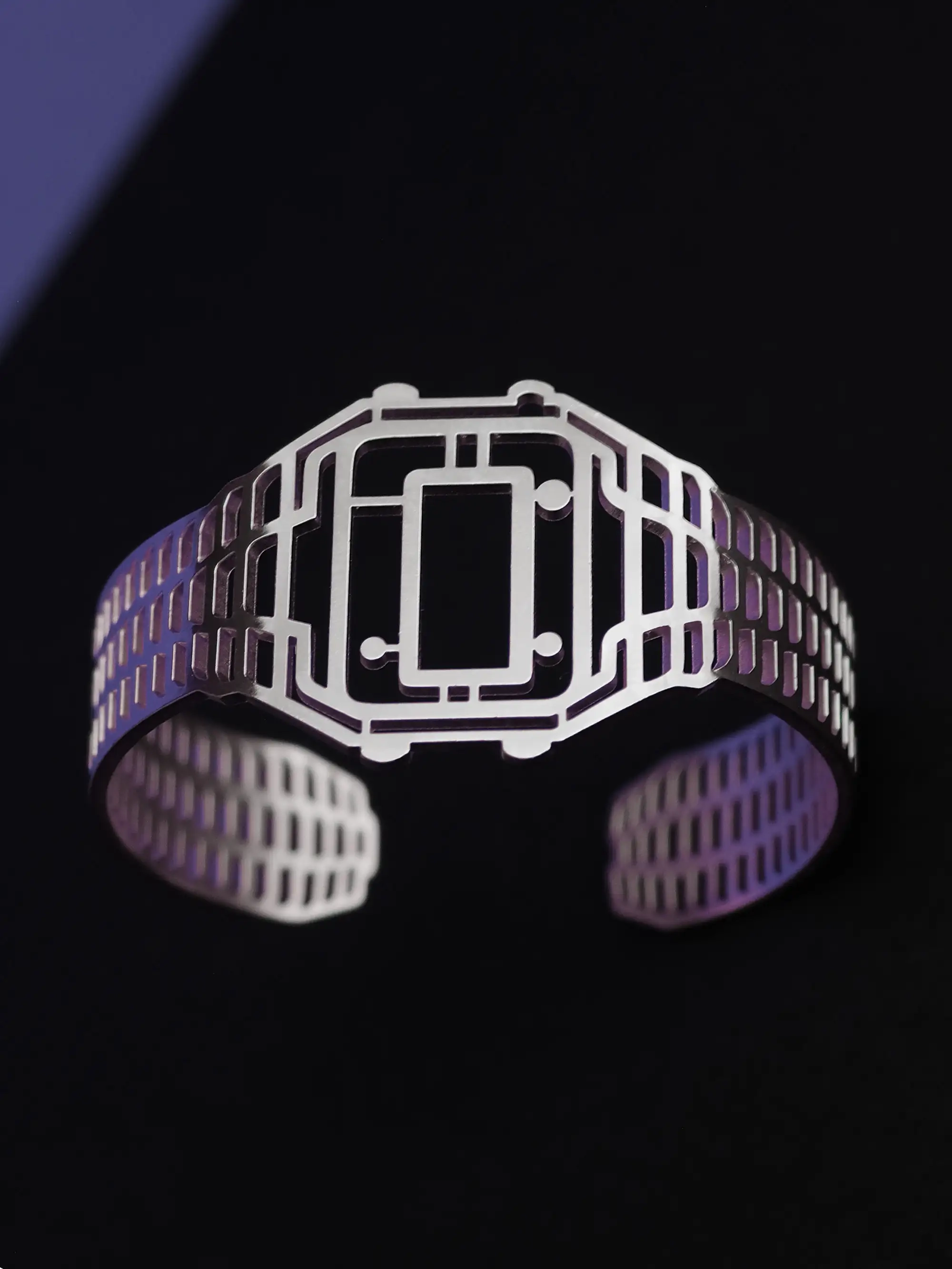 Side-facing silver-plated TIMEPEACE bracelet, minimalist watch-style jewelry with polished metal finish against a black background