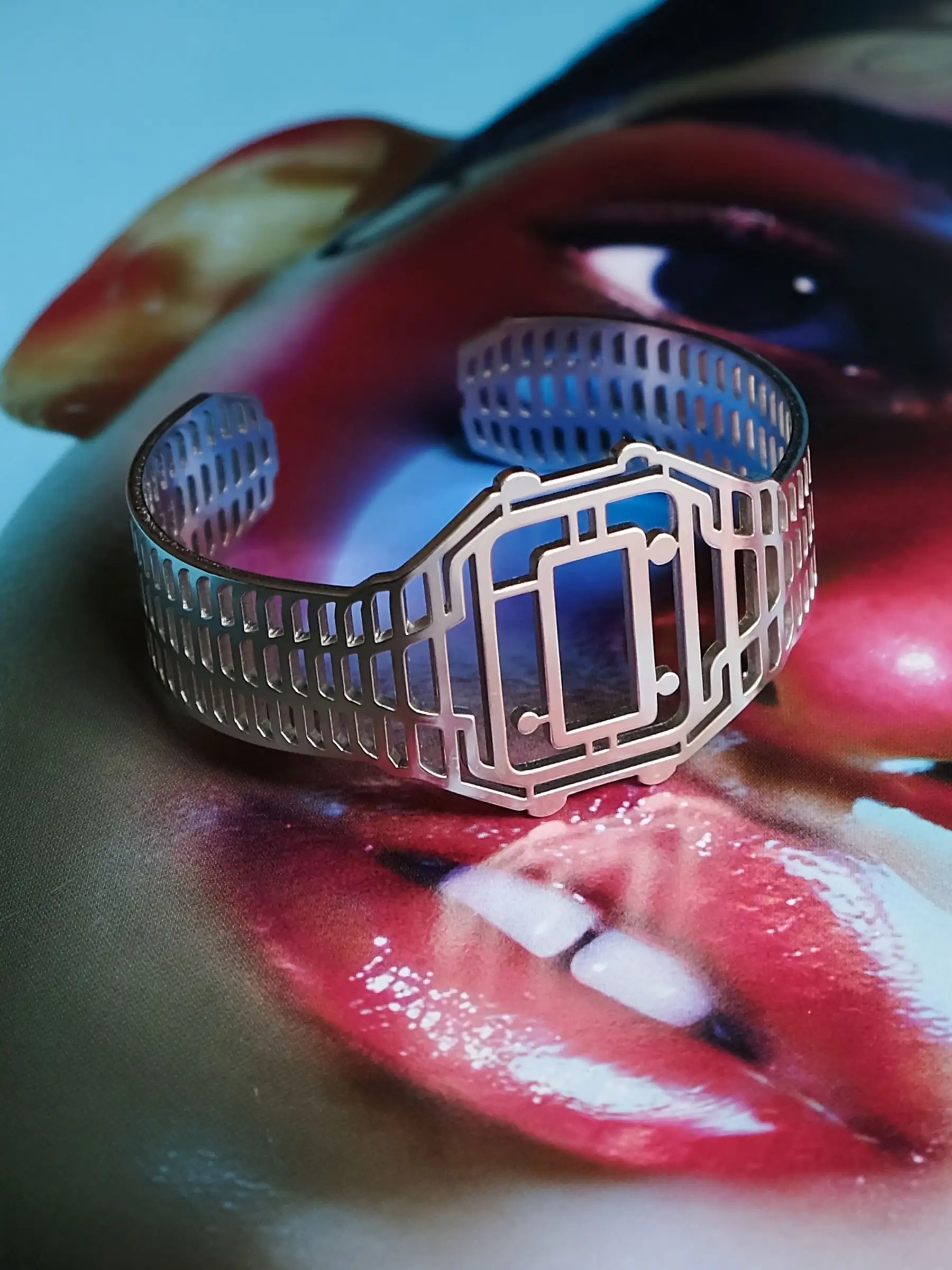 Silver TIMEPEACE bracelet with minimalist design, watch-inspired jewelry shown from the back against a vinyl record cover background