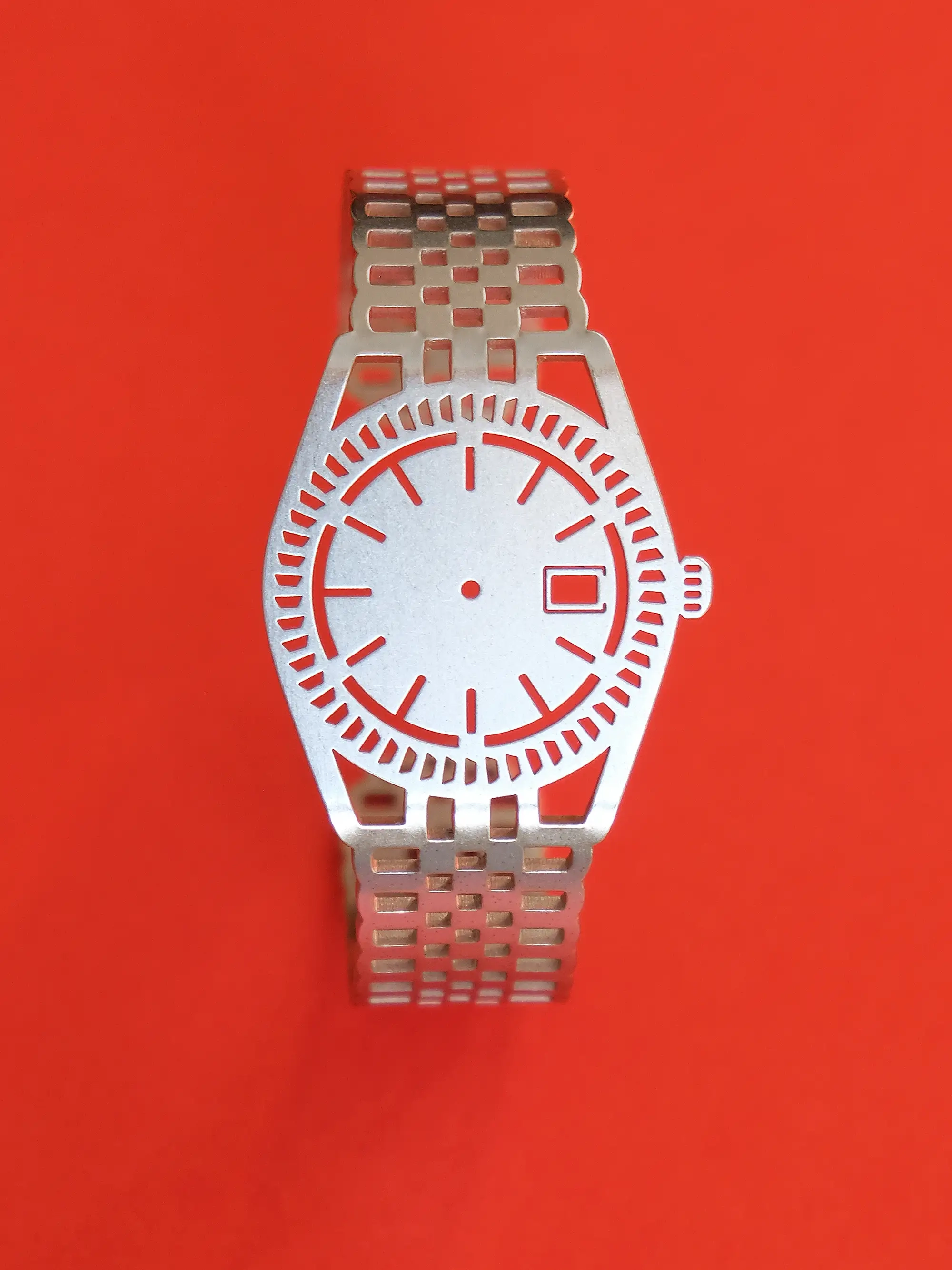 TIMEPEACE minimalist silver bracelet, watch-inspired timepiece jewelry without time, display on red background